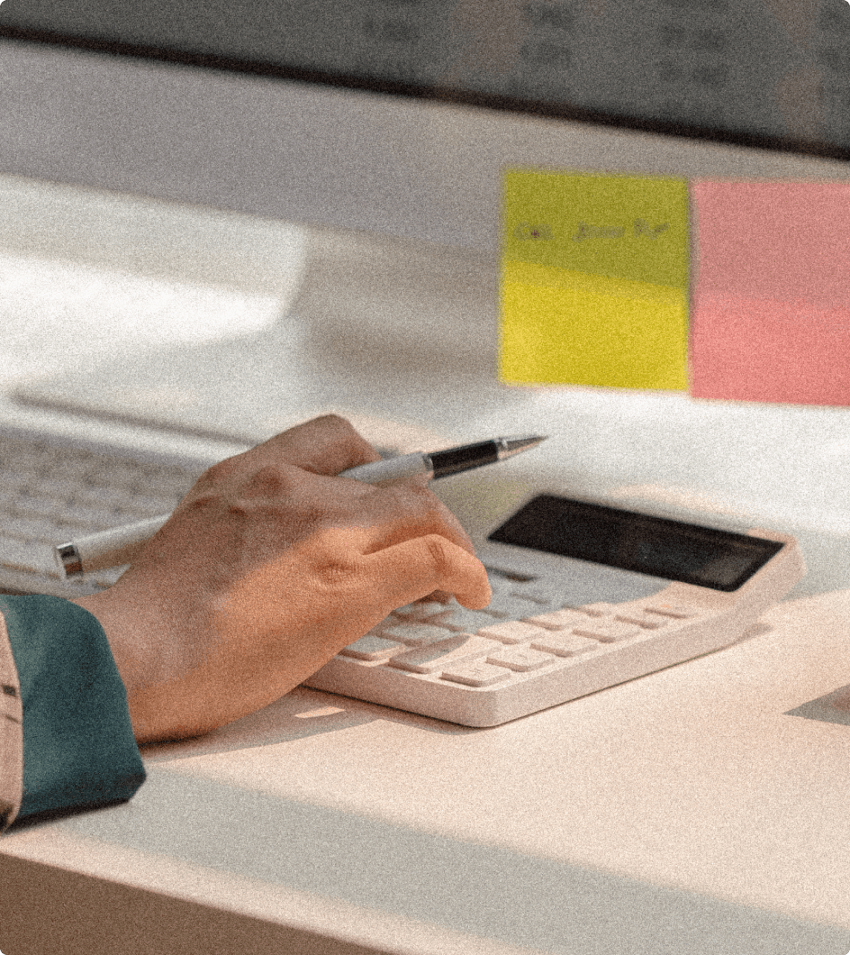 Hand typing on calculator