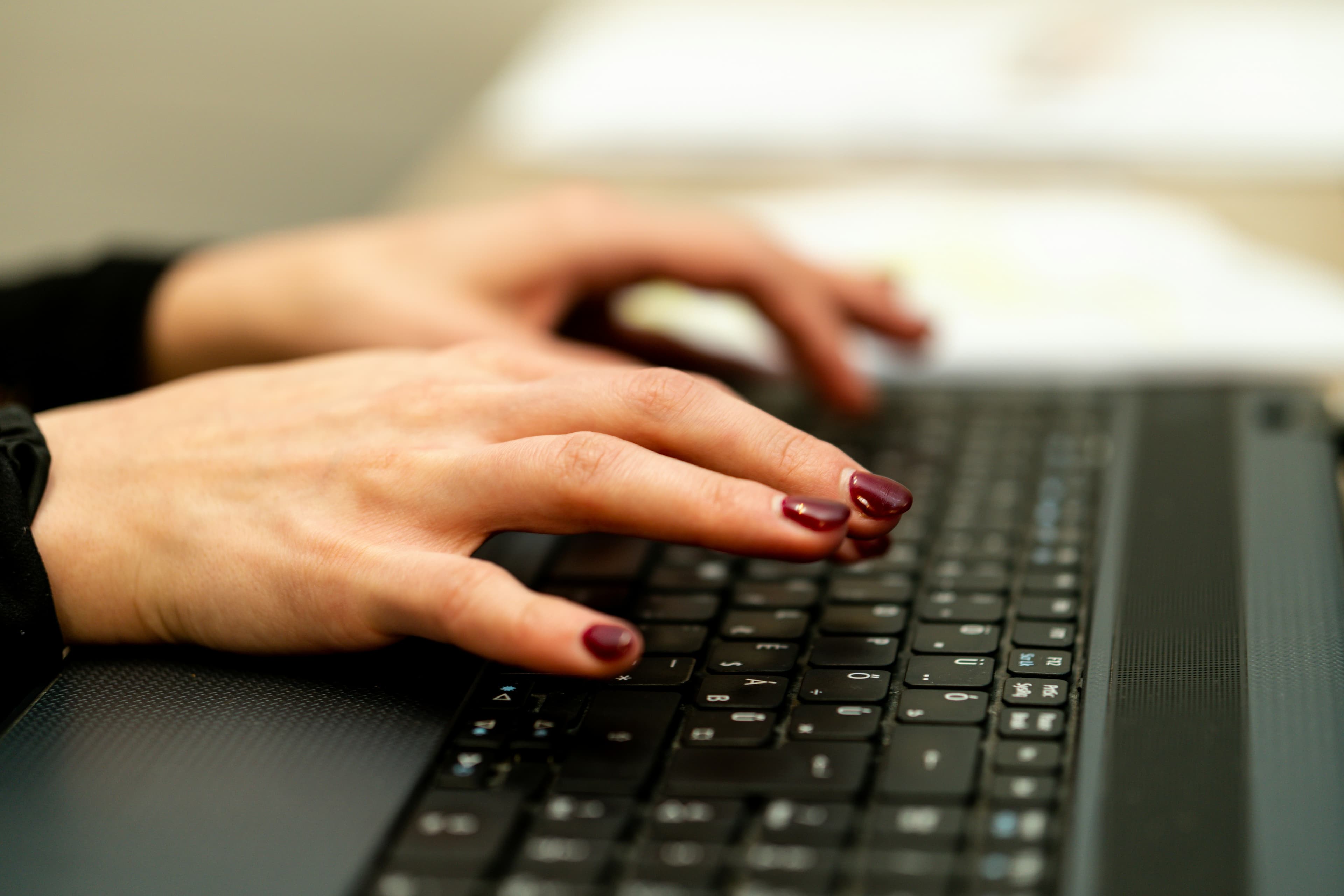 Woman writing introductory email on her laptop